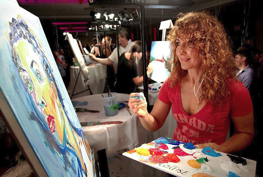 Mary-Louise Scappaticci painting at an art event